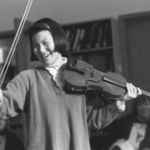 Susan Park dressed as Midori, playing the violin