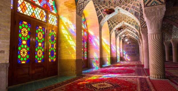 colorful passageway with arched stained glass windows