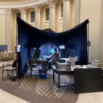 A library staffer works in a blackout tent under MIT's Great Dome